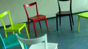 Group Therapy Image for Gay Men's Group and Men's Group pages. It shows a series of colorful chairs in a circle arrangement.