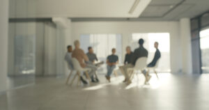 This image is for Dr. Heilman's Interpersonal Psychotherapy Group for Men in Washington DC website page, and shows a picture of blurred men in group therapy.